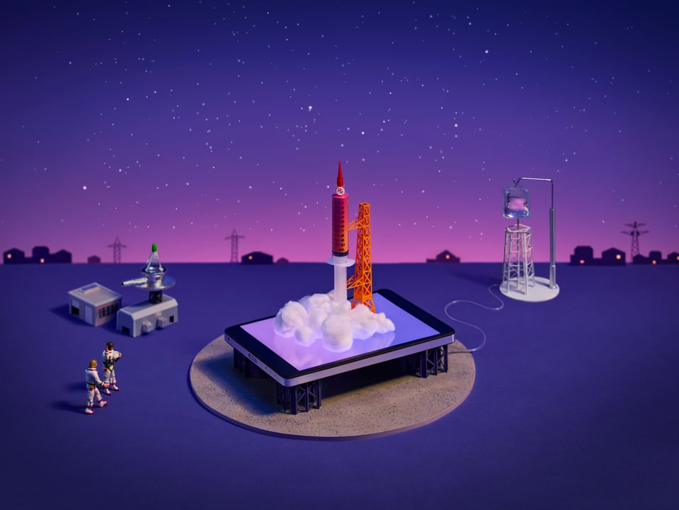 Rocket on a launch pad with astronauts standing around.