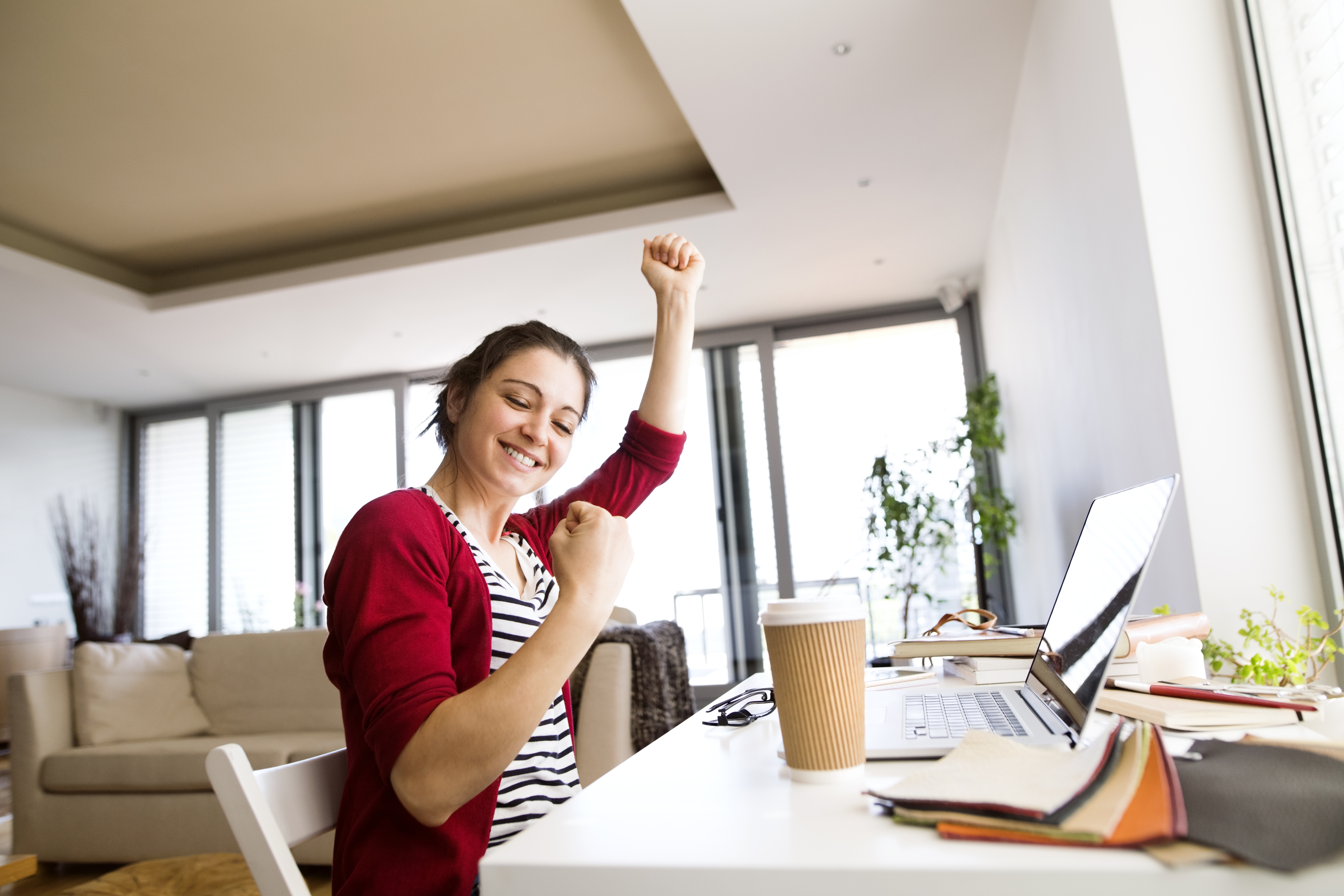 younger woman cheering - happy face